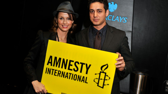 Actress Bridget Moynahan (L) and activist Kianoosh Sanjari attend the Amnesty International Concert presented by the CBGB Festival at Barclays Center