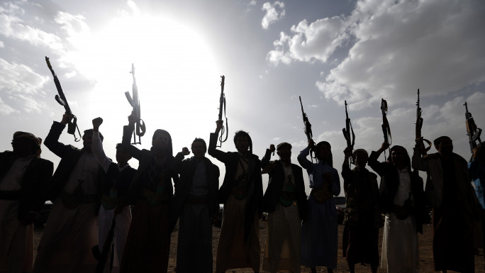 A group of Houthi rebels in Yemen, some pointing rifles in the air