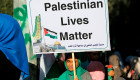 A Palestinian woman holding a placard takes part in a protest against Israel's plan to annex parts of the occupied West Bank, near the Erez crossing with Israel near Beit Hanun in the northern Gaza Strip on July 9, 2020. (MOHAMMED ABED/AFP/via Getty)