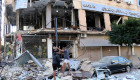 People inspect the damage at the site of an overnight Israeli airstrike that targeted a branch of the Al-Qard Al-Hassan finance group in the southern city of Tyre on October 21, 2024. (Photo by BILAL KASHMAR/AFP via Getty Images)