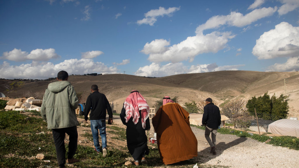 Bedouin men walk in the village of Khan Al-Ahmar on January 30, 2023 in Kan El-Ahmer, West Bank