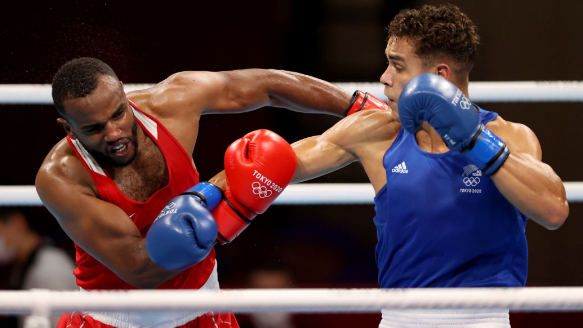 Youness Baalla (L) of Morocco exchanges punches with David Nyika of New Zealand during the Men's Heavy (81-91kg) on day four of the Tokyo 2020 Olympic Games