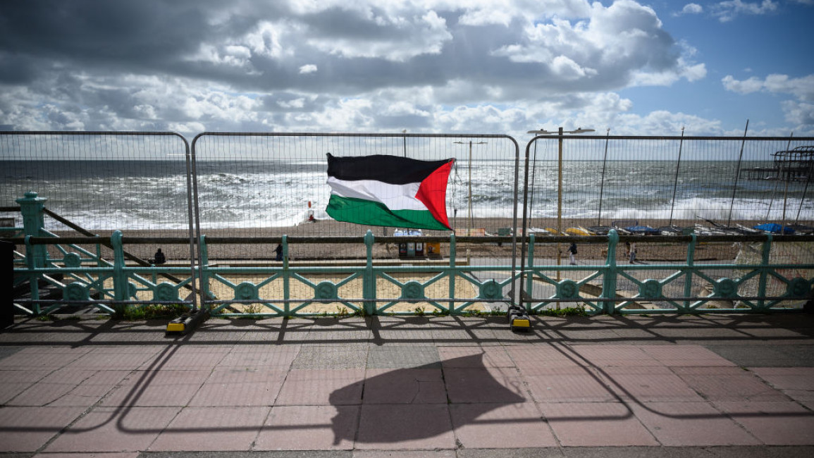 A Palestinian flag blows in the strong winds on the Brighton sea front [Getty Images]