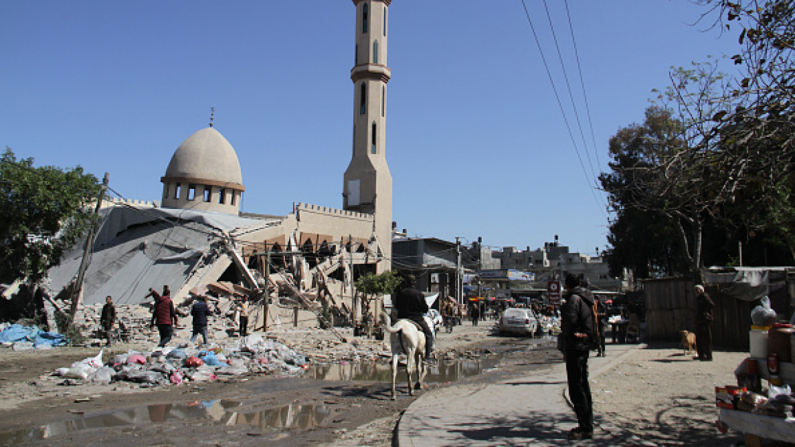 Civilians are seen around the Al-Shuhada Mosque, heavily damaged in the Israeli airstrikes on Jabalia refugee camp in Gaza on March 5, 2024.