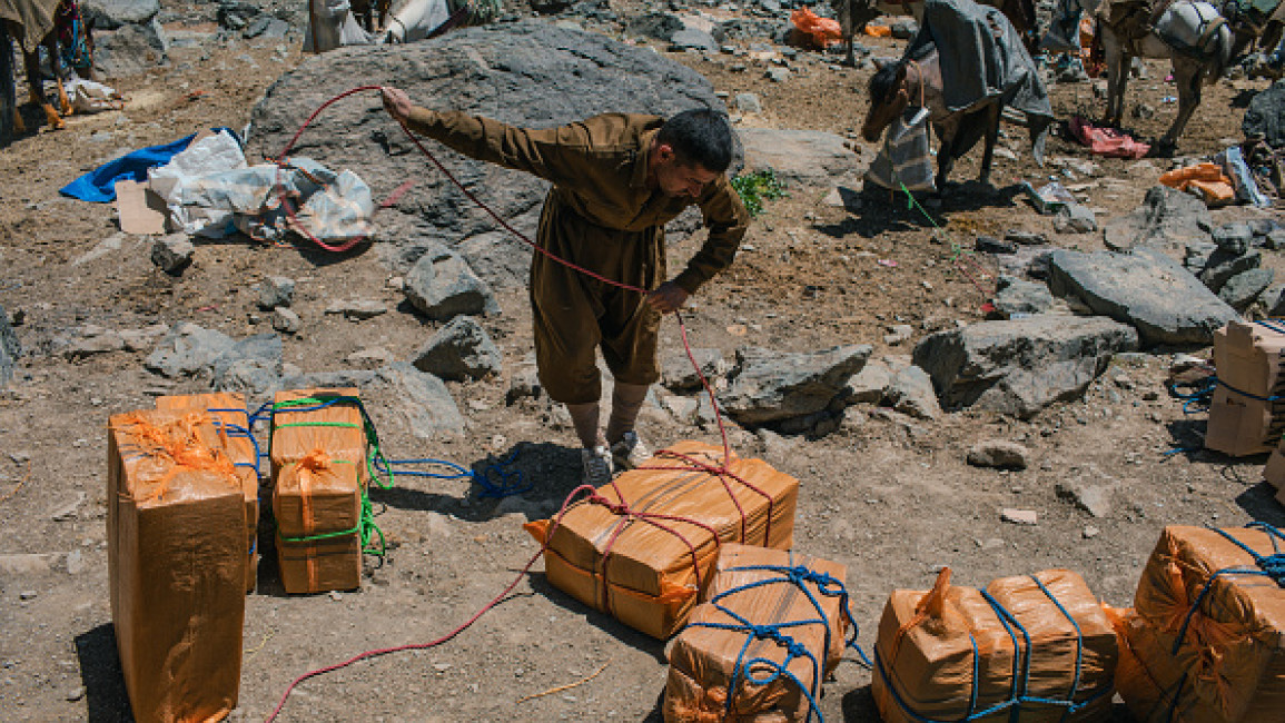 A Kurdish alcohol smugglers prepares boxes of liquor to be smuggled to Iran from the border areas of Iraqi Kurdistan on May 8, 2017.