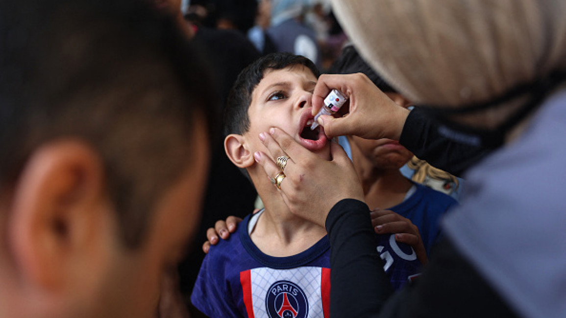 A Palestinian medic administers polio vaccines to children at the al-Daraj neighborhood clinic in Gaza City on September 10, 2024