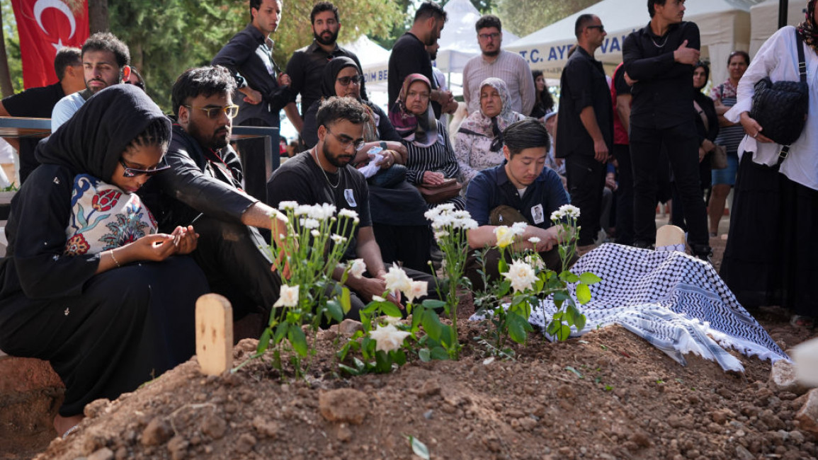 The body of Turkish American activist Aysenur Ezgi Eygi is buried in Didim Asri Cemetery as her husband Hamid Mazhar Ali (3rd L) stand her grave during the funeral ceremony in Didim distict, Aydin, Turkey on 14 September 2024