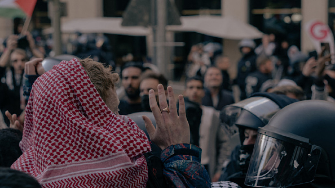 A man wearing a keffiyeh is pushed by German police at a demonstration in solidarity with Palestine in Berlin, Germany, on September 14, 2024.