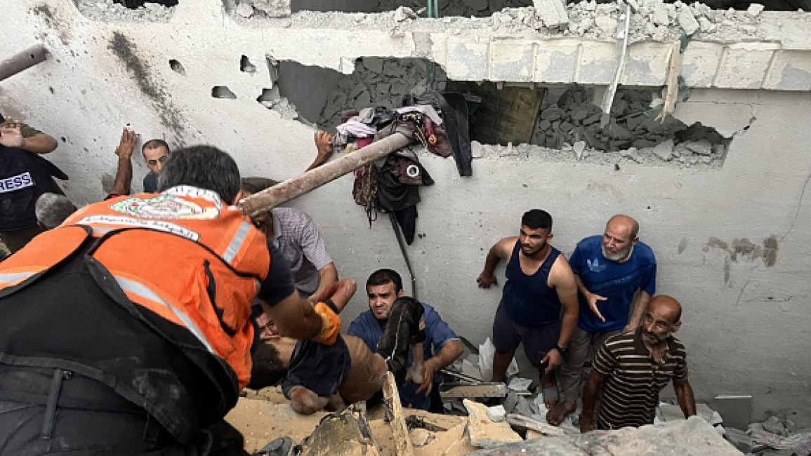 Palestinian residents extract the bodies during the search and rescue operations among the rubbles of demolished house following an Israeli attack on a house at Nuseirat Refugee camp in Gaza City, Gaza on September 16, 2024. At least 10 people died and 13 injured. (Photo by Hassan Jedi/Anadolu via Getty Images)