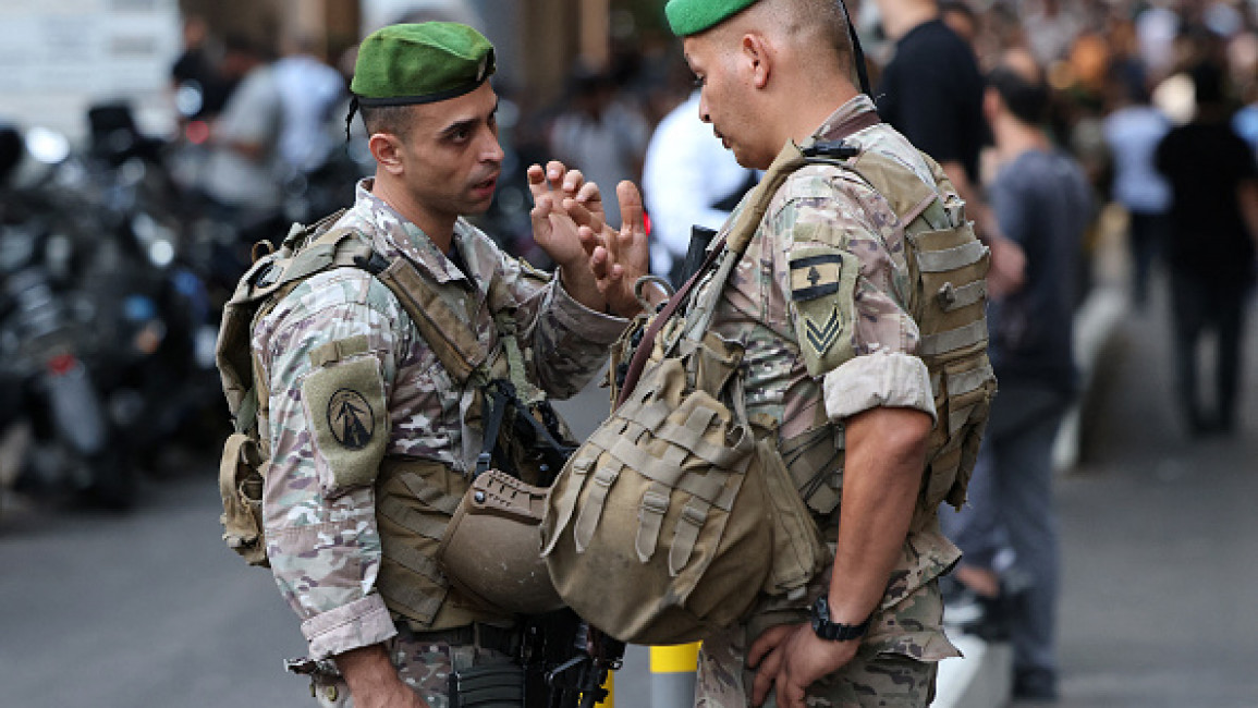 Lebanese army soldiers stand guard at the entrance of a hospital (background) in Beirut on September 17, 2024, after explosions hit locations in several Hezbollah strongholds around Lebanon amid ongoing cross-border tensions