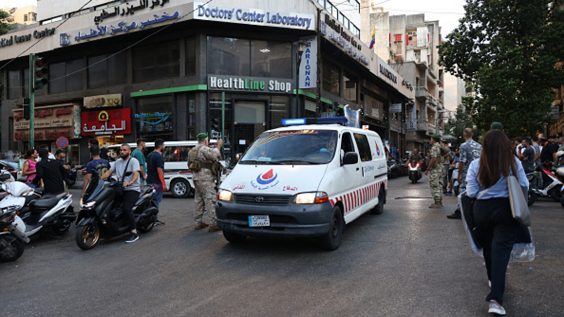 Lebanese army soldiers stand guard as an ambulance rushes wounded people to a hospital in Beirut on September 17, 2024, after explosions hit locations in several Hezbollah strongholds around Lebanon