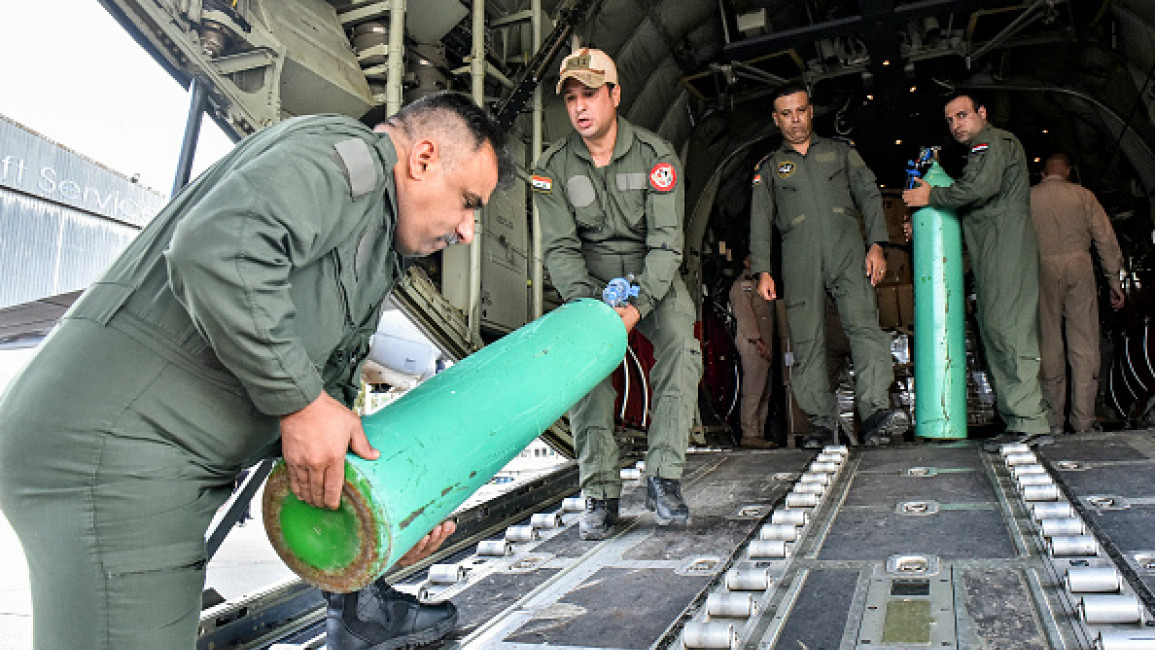 Iraqi Air Force airmen unload an oxygen tank off of a C-130 Hercules military transport aircraft upon arrival at Beirut Airport on September 18, 2024 with a shipment of emergency medical aid provided by Iraq to Lebanon. (Photo by Fadel Itani/AFP)