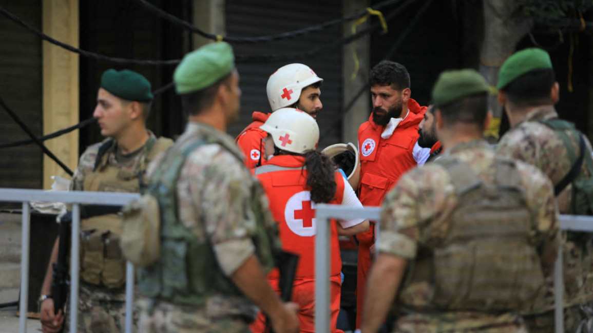 Lebanese army soldiers and Red Cross rescuers gather at the barriered area of the scene of an Israeli strike that targeted Beirut's southern suburbs a day earlier, as search and rescue operations continue on September 21, 2024. (Photo by AFP)