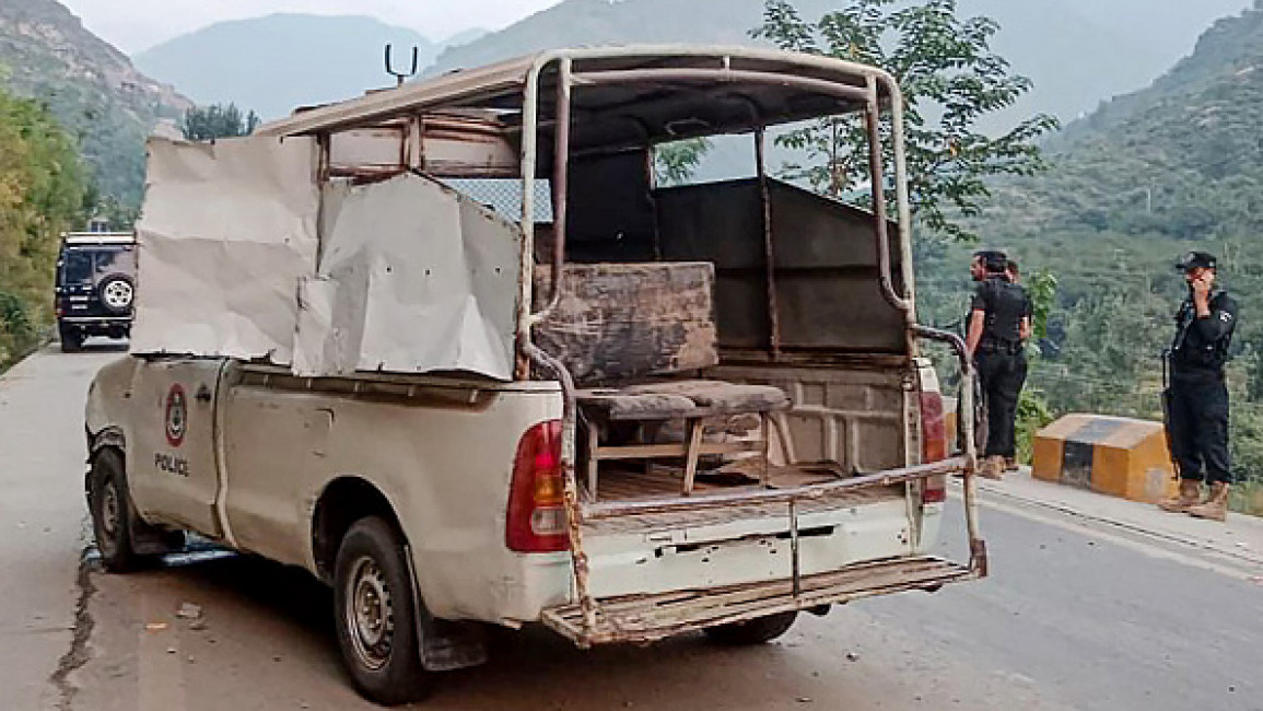 Security personnel stand near a damaged police vehicle at the site of a bomb explosion, in Malam Jabba at Swat district of Khyber Pakhtunkhwa province on September 22, 2024. (Photo by MEHBOOB UL HAQ/AFP via Getty Images)