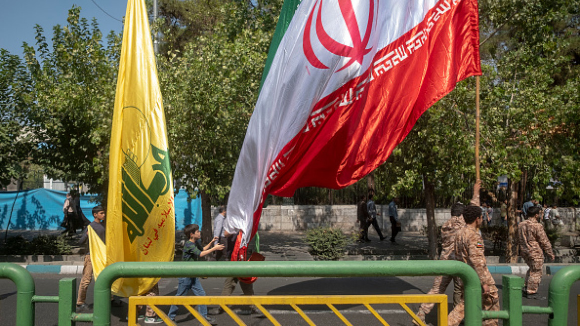 An Iranian flag and a flag of Lebanon's Hezbollah carried before an anti-Israeli protest to condemn Israel's military attack on Lebanon during Friday prayers ceremonies in downtown Tehran, Iran, on September 27, 2024