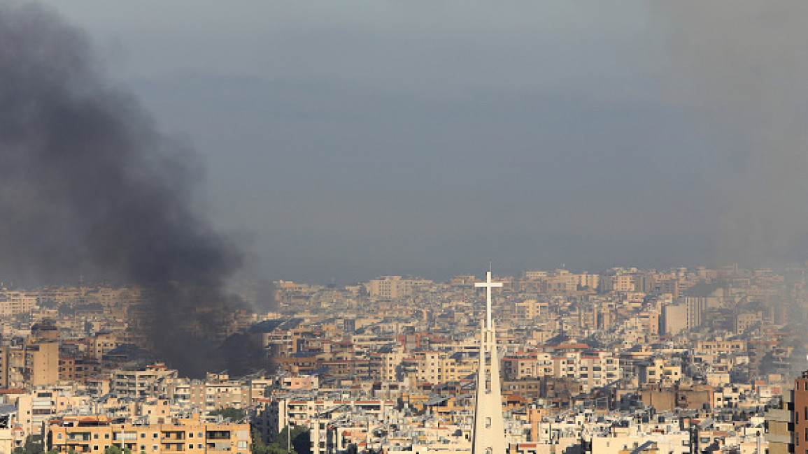 A picture taken from the hills east of Beirut shows smoke billowing during Israeli airstrikes on the southern suburbs of the Lebanese capital early on September 28, 2024. 