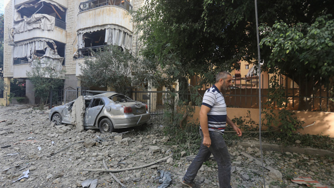 A man walks through the rubble as people check on September 28, 2024 the devastation in the Hadath neighbourhood of Beirut's southern suburbs in the aftermath of overnight Israeli airstrikes on the outskirts of the Lebanese capital.