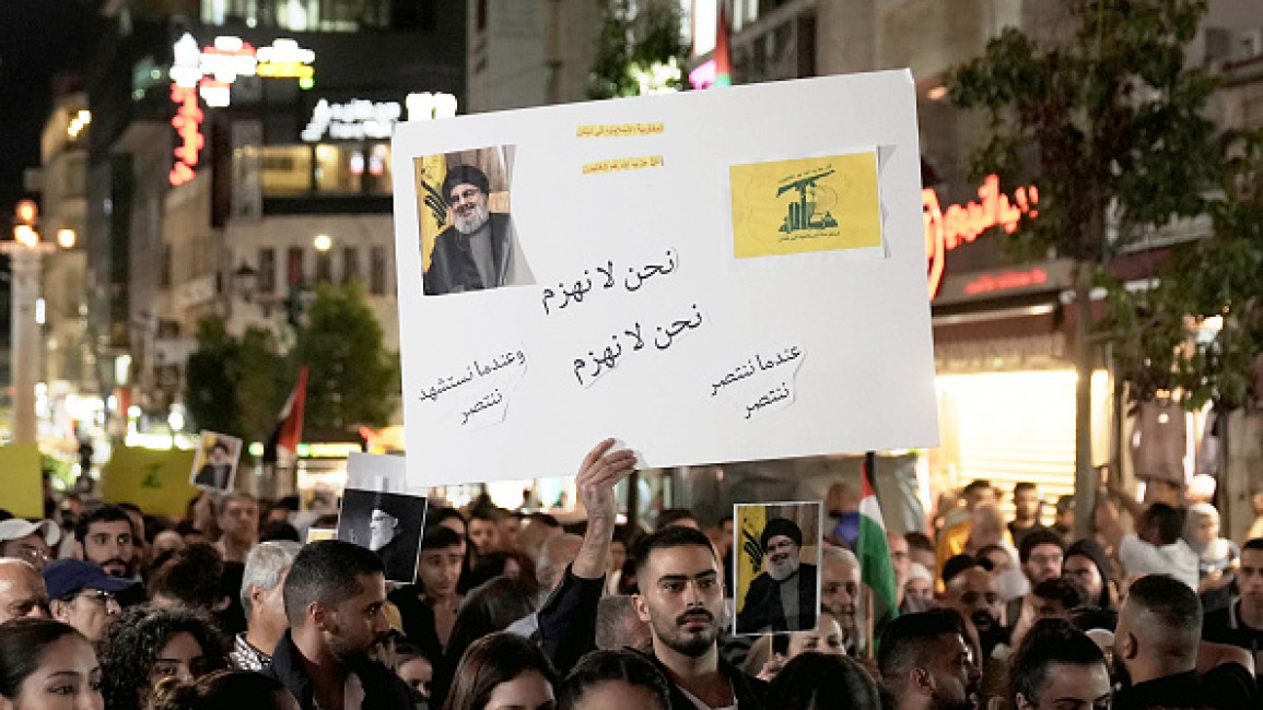 People, holding banners and flags, gather to stage protest against Israel following Nasrallah's assassination on September 28, 2024 in Ramallah, West Bank. (Photo by Issam Rimawi/Anadolu via Getty Images)