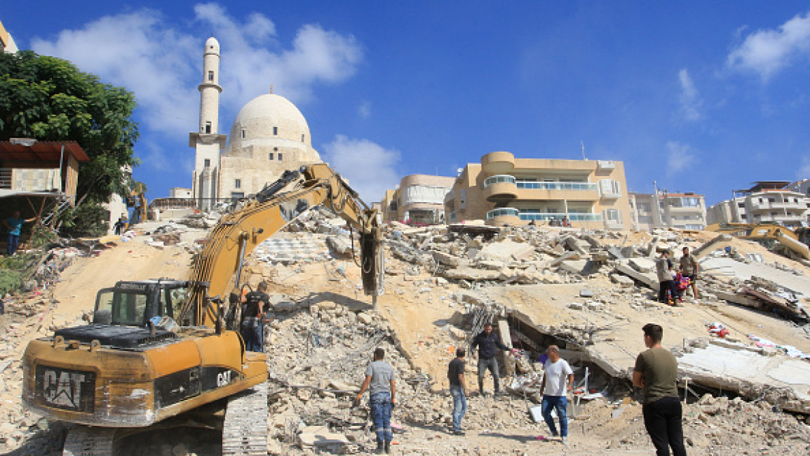 Rescuers dig through the rubble of a building, a day after it was hit in an Israeli strike, in the southern Lebanese village of Ain El Delb on September 30, 2024. (Photo by MAHMOUD ZAYYAT/AFP via Getty Images)