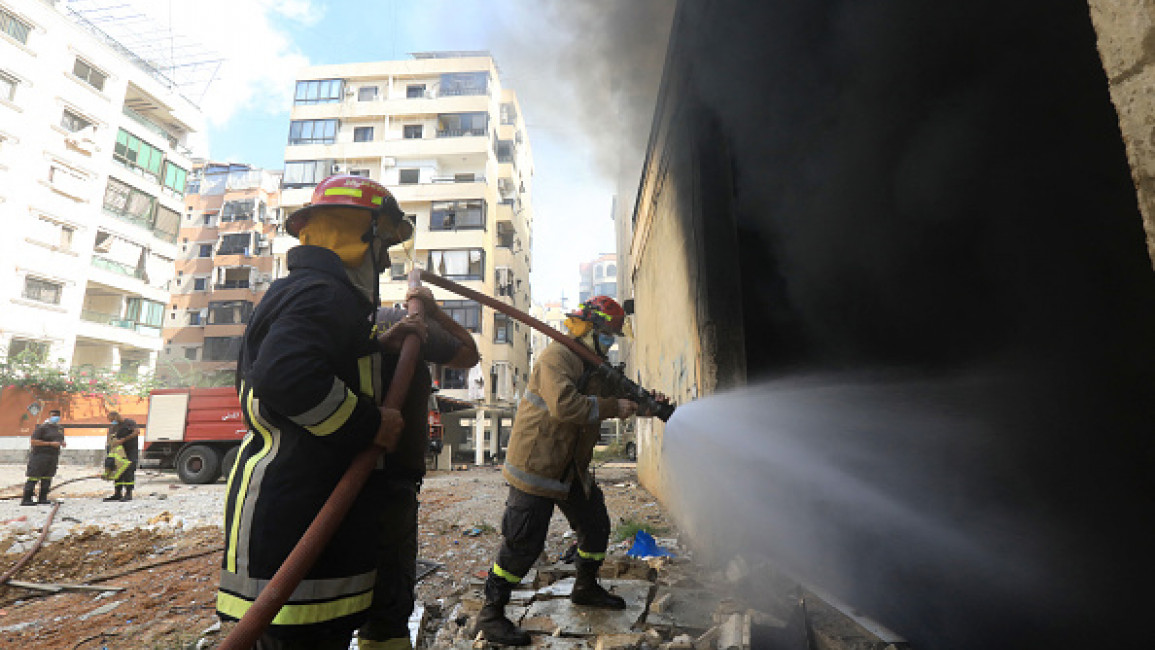 Firefighters work at the site of an overnight Israeli airstrike in Beirut's southern suburb of Shayyah on October 2, 2024.