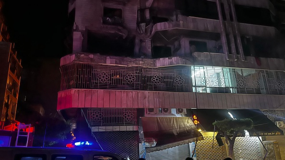 People gather at the site of an Israeli airstrike that targeted an apartment building in Beirut's Bashura neighborhood on October 3, 2024. (Photo by IBRAHIM AMRO/AFP via Getty Images)