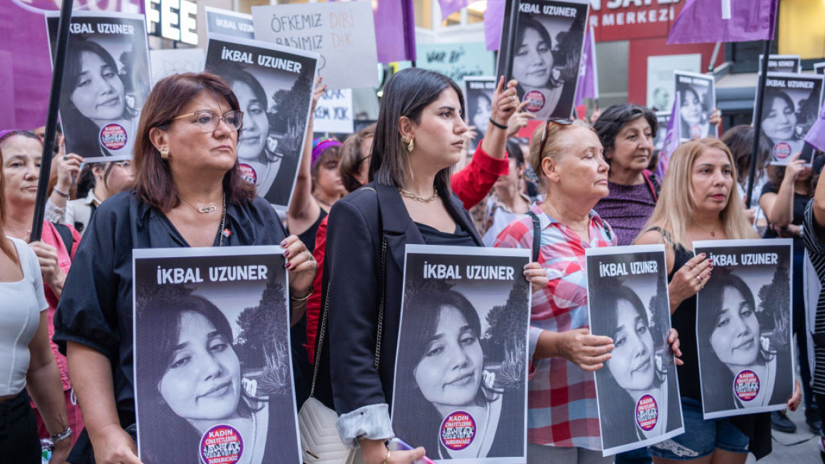 Women hold Ikbal Uzuner's portraits during the demonstration against femicide in Izmir