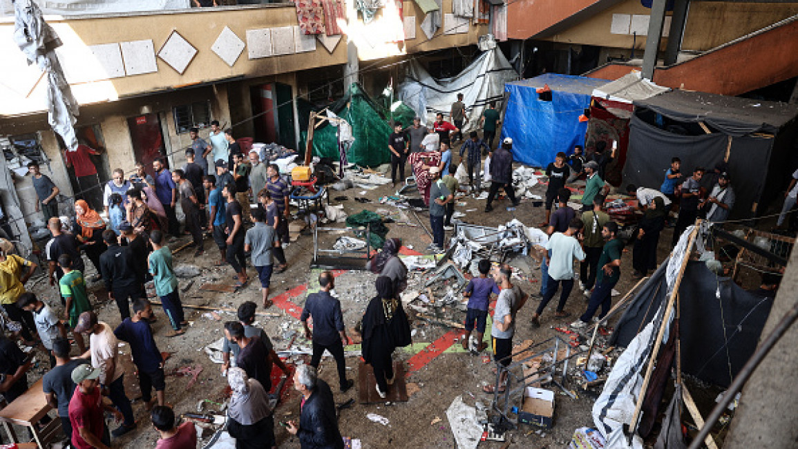 Palestinians react after an Israeli airstrike hit the Rafida school sheltering displaced people in Deir al-Balah in the central Gaza Strip on October 10, 2024. (Photo by EYAD BABA/AFP via Getty Images)