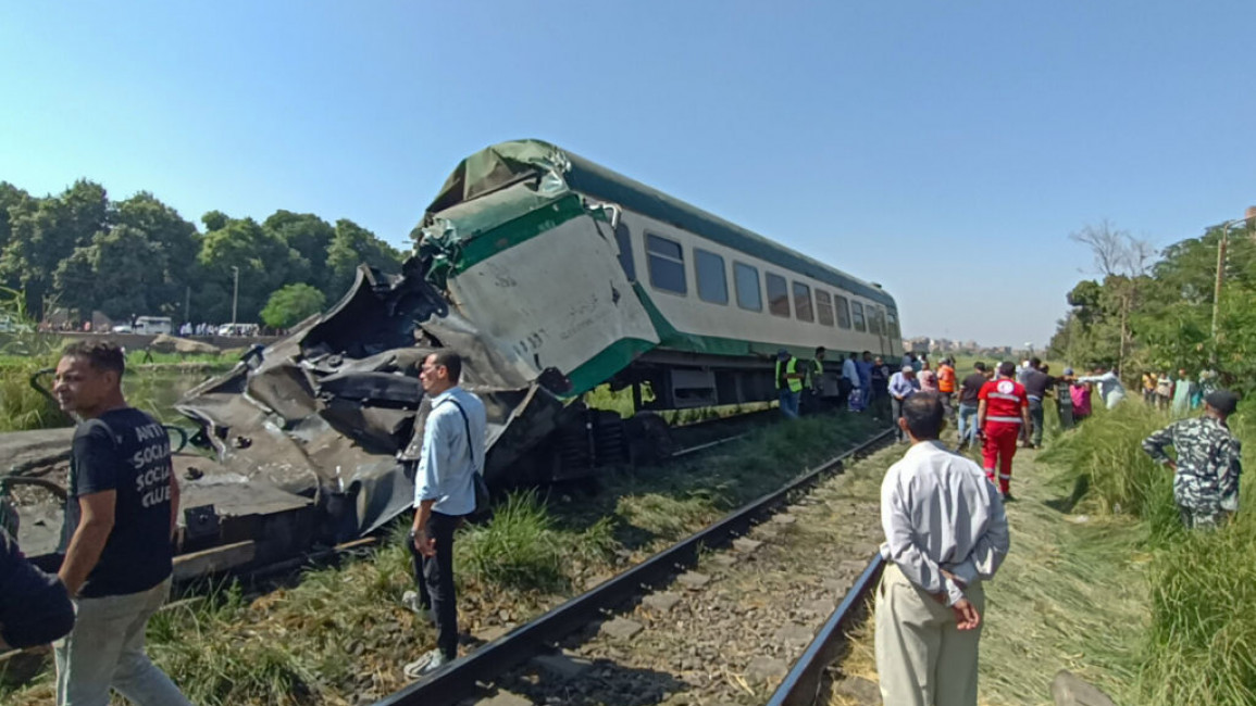 Emergency teams respond to the scene after a train collision that caused two carriages to plunge into an irrigation canal in Minya