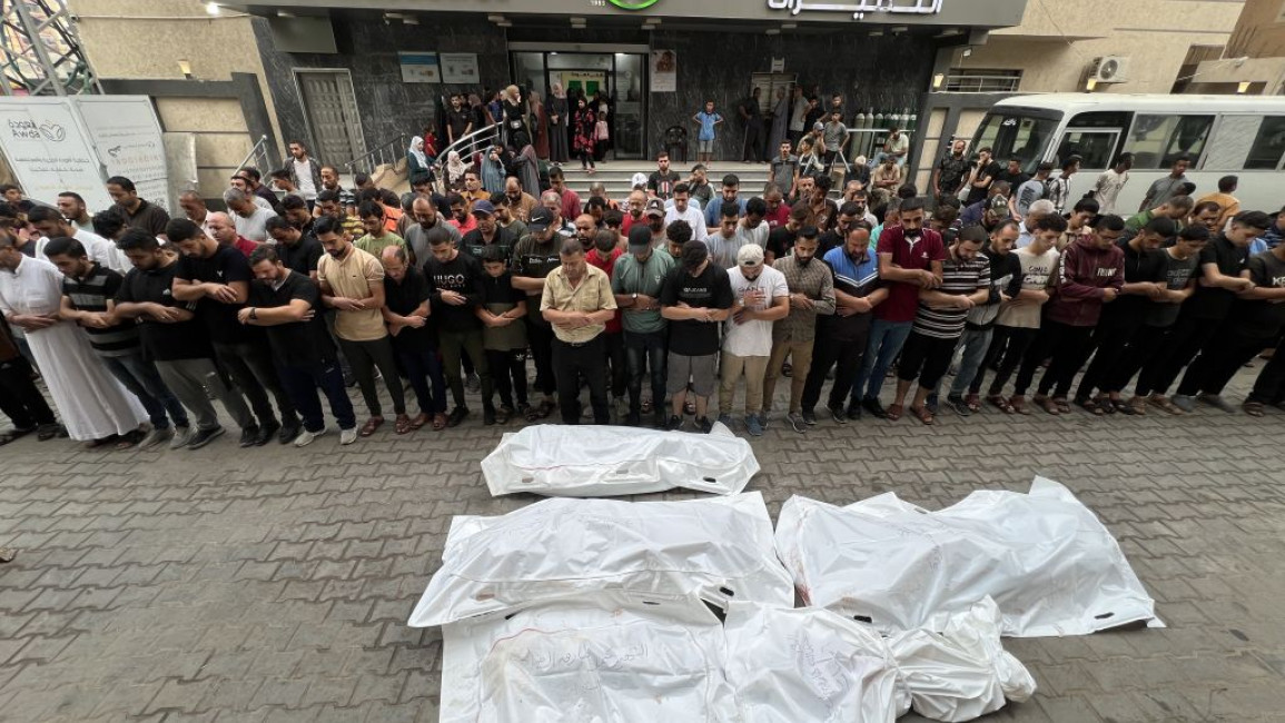 Relatives of Palestinians perform funeral prayer at Al-Awda Hospital in Gaza City