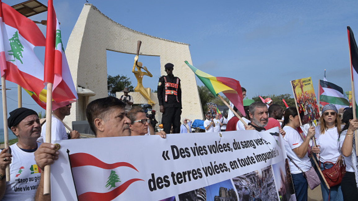 Demonstrators gather in front of the Millenium Gate in Dakar on October 19, 2024 during a march calling for peace and justice for Lebanon and Gaza.