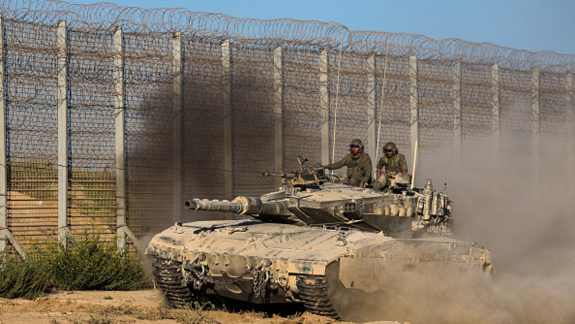 Israeli soldiers patrol in a tank along the Israel-Gaza border area on October 21, 2024, amid the ongoing war on the Palestinian territory.