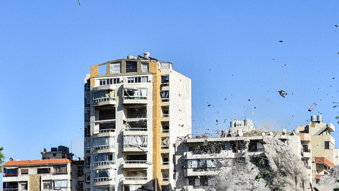 A rocket fired by an Israeli war plane approaches a building in Beirut's southern suburb of Shayah