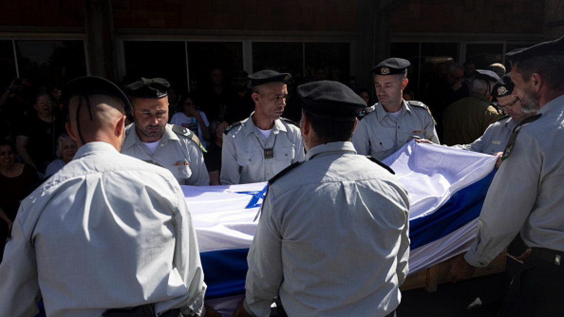 Israeli soldiers carry a coffin covered with Israeli flag during a funeral for Warrant Officer (res.) Guy Idan, 51, on October 25, 2024 in Shomrat, Israel. (Photo by Amir Levy/Getty Images)