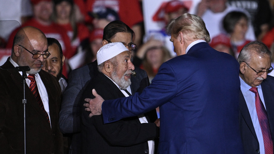 Former US President and Republican presidential candidate Donald Trump greets local leaders of the Muslim community