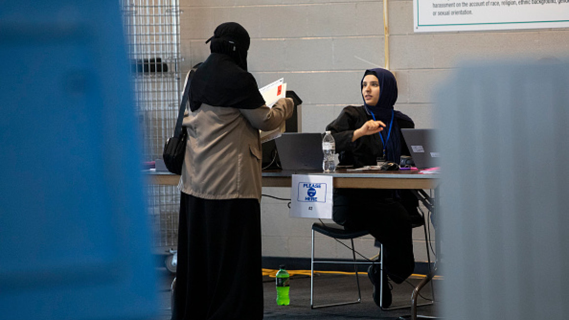 : Voters cast their ballots during Michigan's early voting period on October 29, 2024 in Dearborn, Michigan. Early voter turnout has been heavy in Michigan, a key battleground state with 14 electoral votes, with over 250,000 early votes being cast in just the first two days.