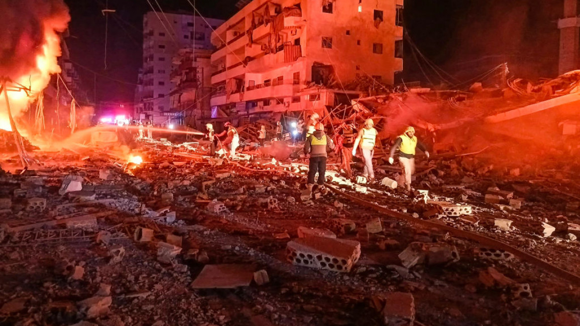 First responders battle flames following an Israeli airstrike that targeted the industrial zone in the southern Lebanese village of Abbasiyeh near Tyre