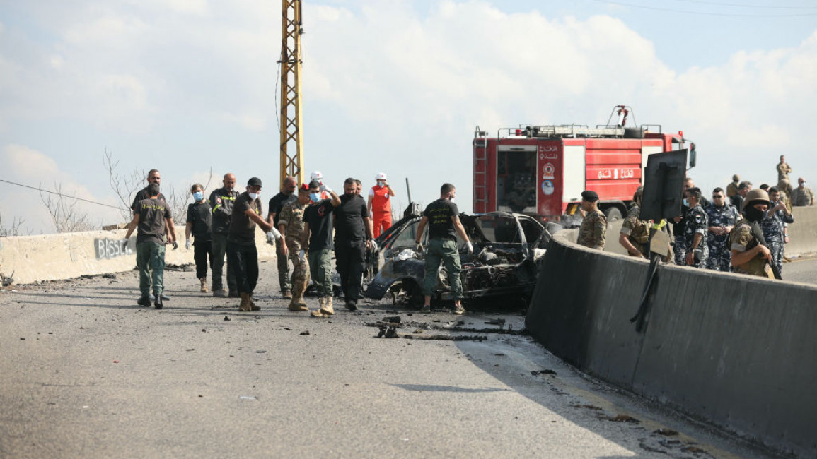 Rescuers arrive to the site of an Israeli drone attack that targeted a vehicle on the international Beirut-Damascus road in the area of Araya east of Beirut 