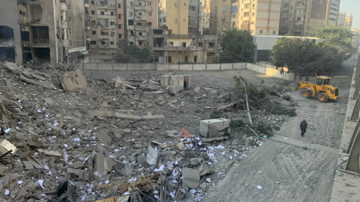 A man walks in front of a building, flattened in an overnight Israeli airstrike that targeted a neighbourhood in Beirut's southern suburbs on November 1, 2024, 