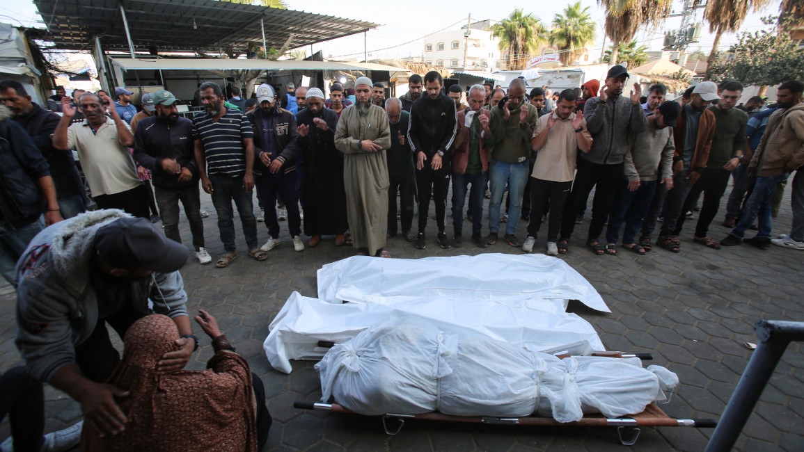 A woman reacts as others recite a prayer over the bodies of victims killed an Israeli strike on the Nuseirat refugee camp, in front of the al-Aqsa Martyrs hospital in Deir el-Balah in the central Gaza Strip, on November 1, 2024