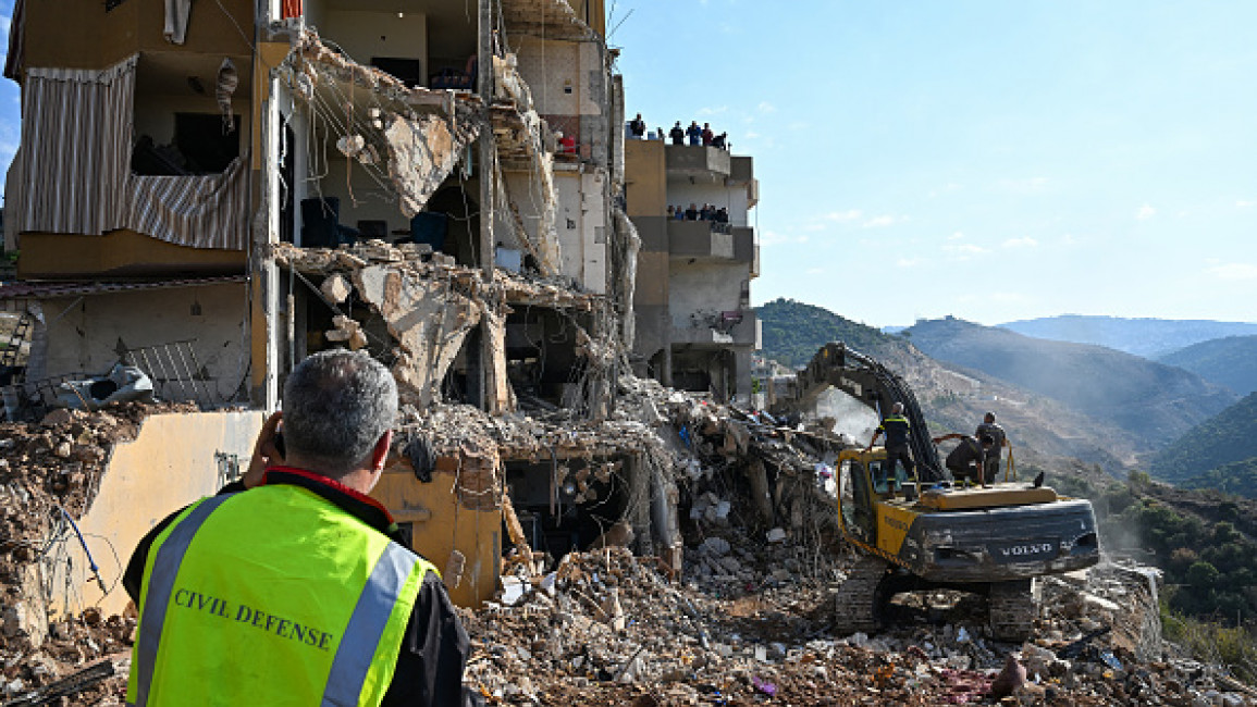 Lebanese emergency and security services inspect the rubble at the site of an Israeli strike a day earlier on a residential building in Lebanon's Barja town, on November 6, 2024. (Photo by JOSEPH EID/AFP via Getty Images)