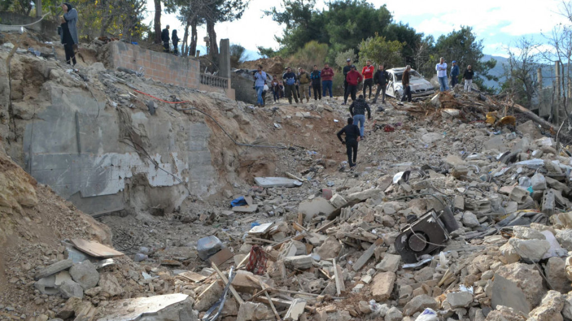 Local residents gather at the site of an overnight Israeli strike in Ain Yaacoub, Akkar region, Lebanon