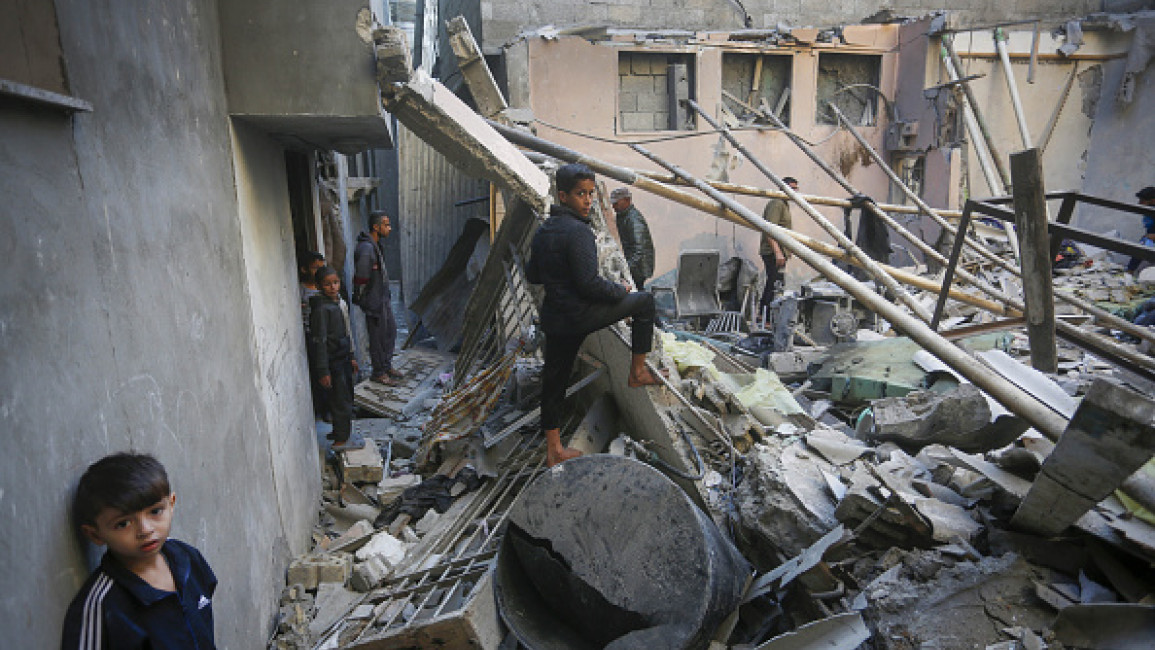 : Children walk on debris of the destroyed building, belonged to Palestinian Thabt family, after an Israeli attack in Nuseirat Refugee Camp of Deir al-Balah, Gaza on November 13, 2024.