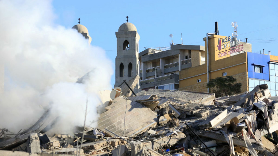 A church stands behind a destroyed building following an Israeli airstrike that targeted the Hadath neighbourhood in Beirut's southern suburbs on November 17, 2024, amid the ongoing war between Israel and Hezbollah Photo by AFP) (Photo by -/AFP via G