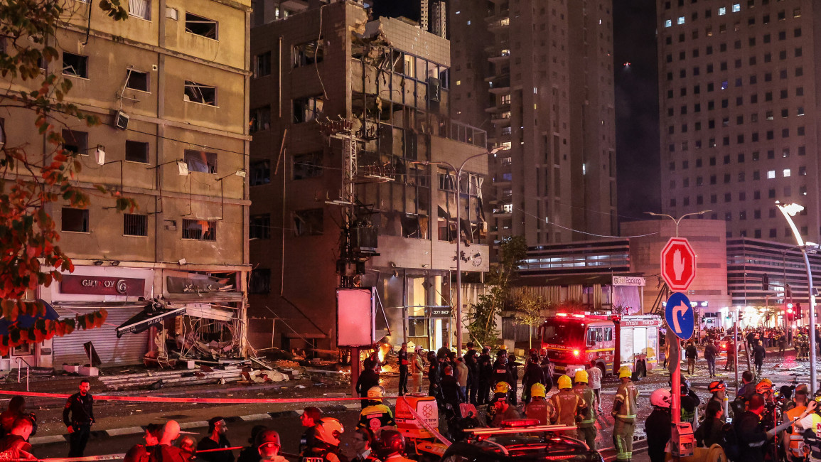 Israeli security services stand in front of a heavily damaged building at the site of a rocket attack from southern Lebanon in Ramat Gan, north of Tel Aviv, on November 18, 2024, amid the ongoing war between Israel and Hezbollah. (Photo by Jack GUEZ)