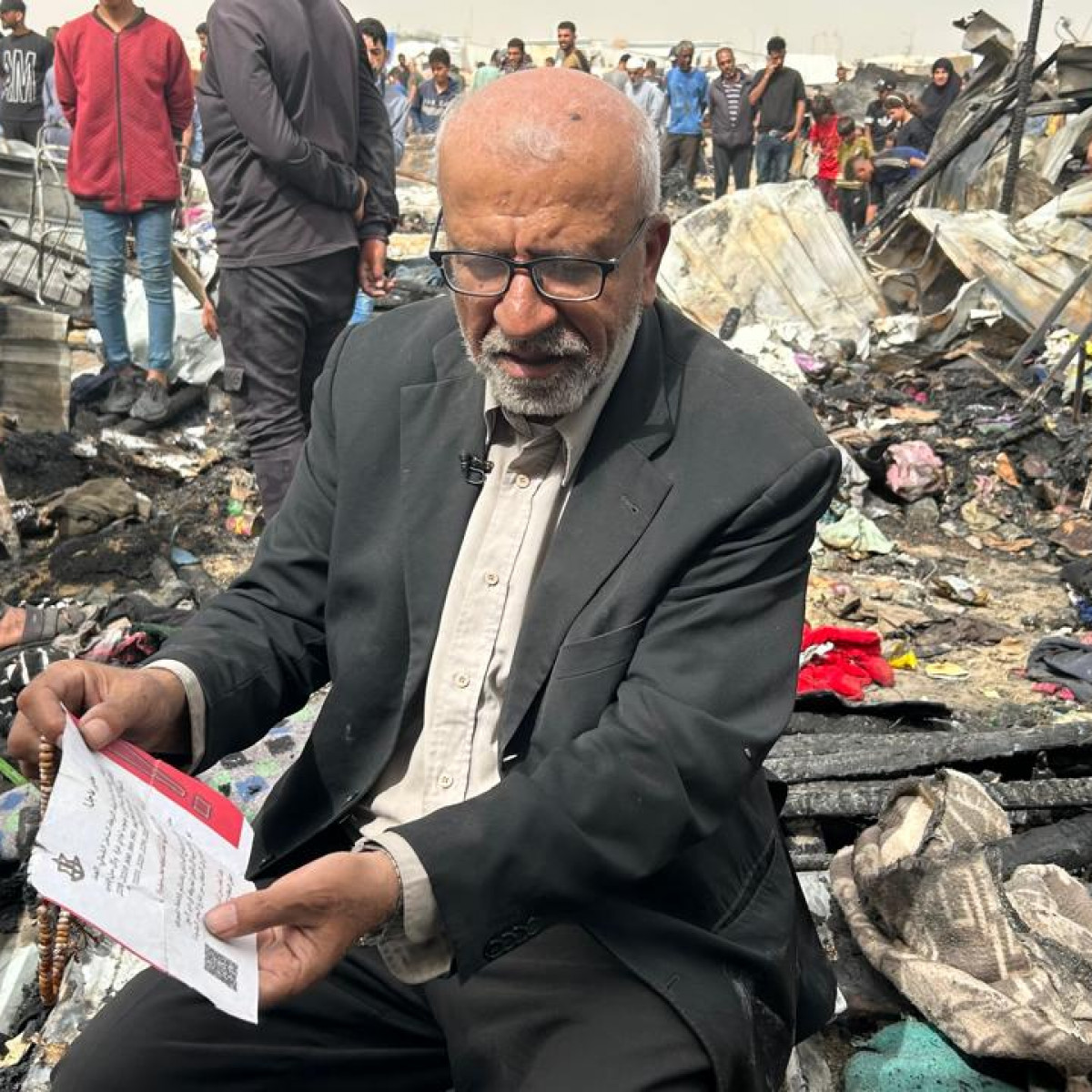 Samir Al-Sabh, a survivor of the Rafah attack, has kept the leaflet which drove him out of his home months ago, and which clearly said that they must go to the 'safe' city of Rafah. [Mohamed Solaimane/TNA]